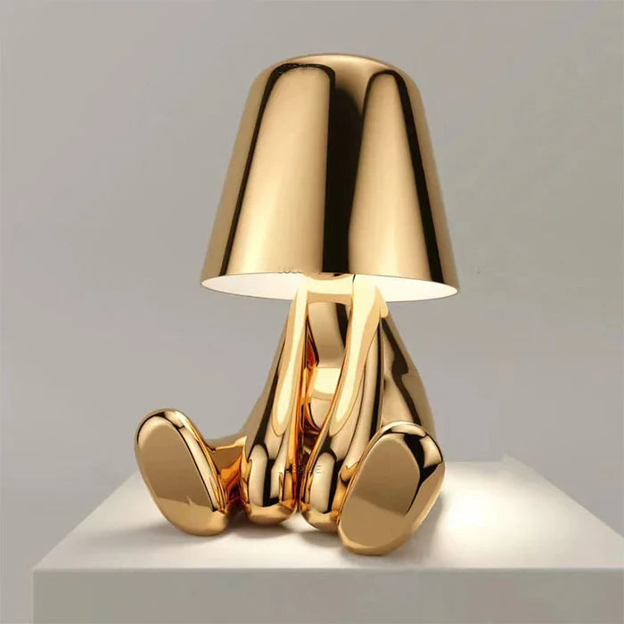 Designerska lampa stołowa LED siedzący człowiek z połyskującym wykończeniem