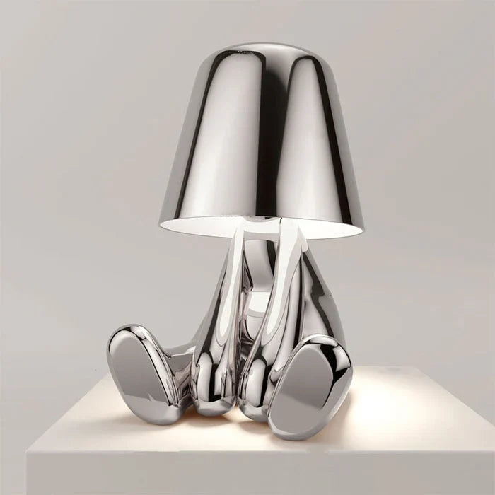 Designerska lampa stołowa LED siedzący człowiek z połyskującym wykończeniem